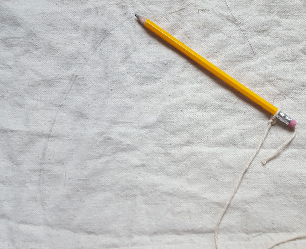 Slipcovered ottoman in white pencil