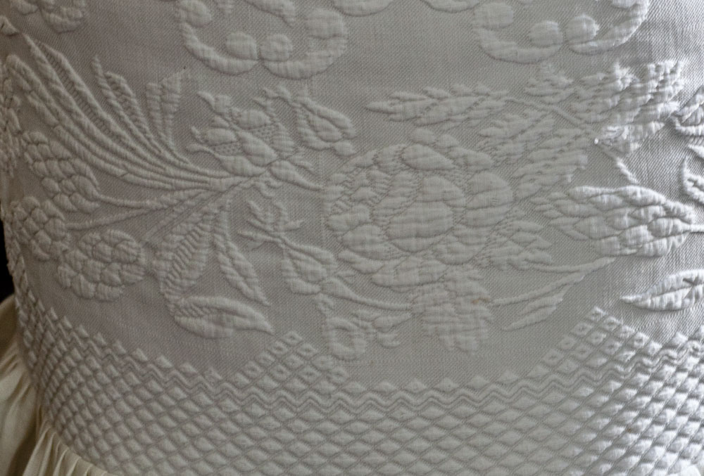 Slipcovered ottoman in white pattern