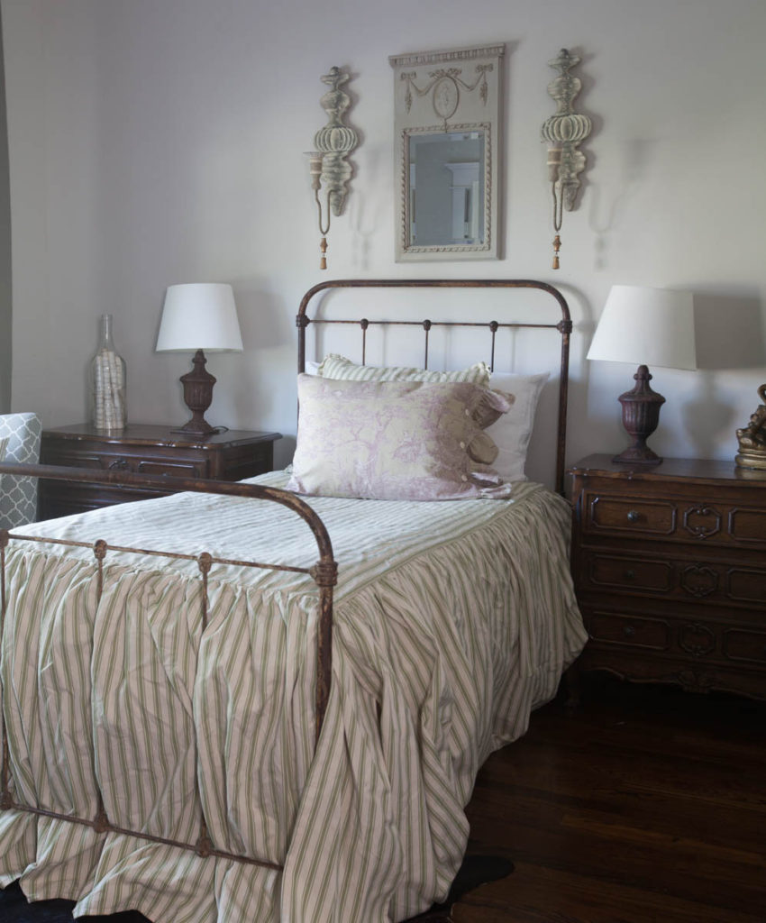 toile pillow on striped bed