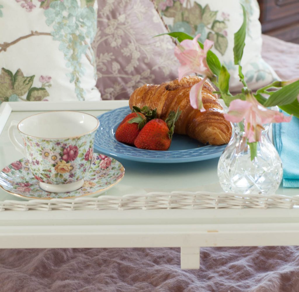 rose linen sheets and croissants