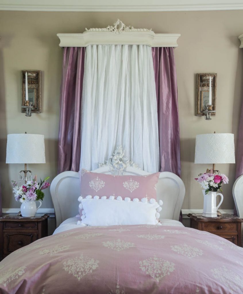 pink curtains behind bed and duvet